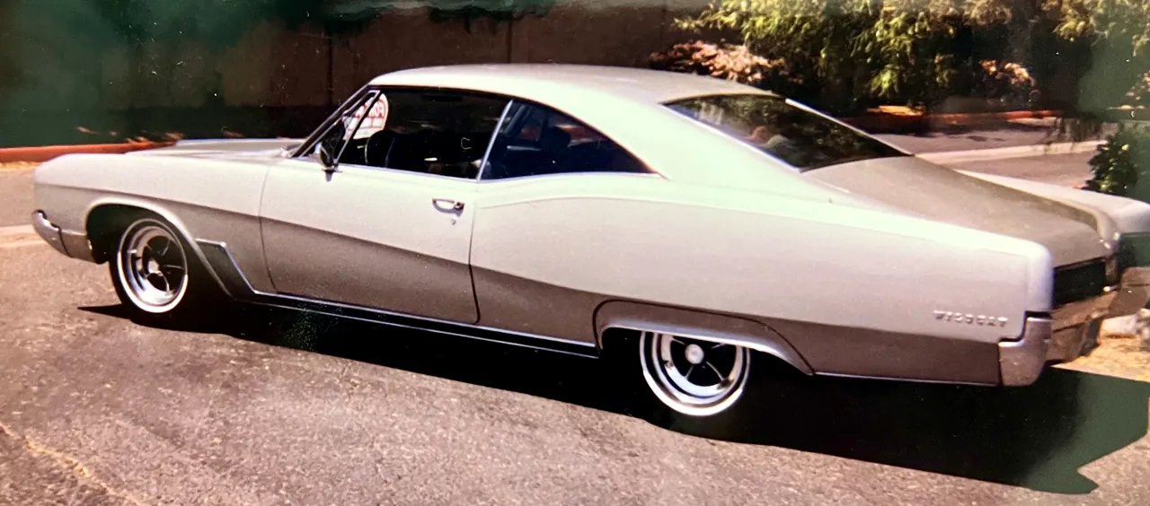 A white Chevrolet two-door hardtop with a long roofline, parked on a driveway
